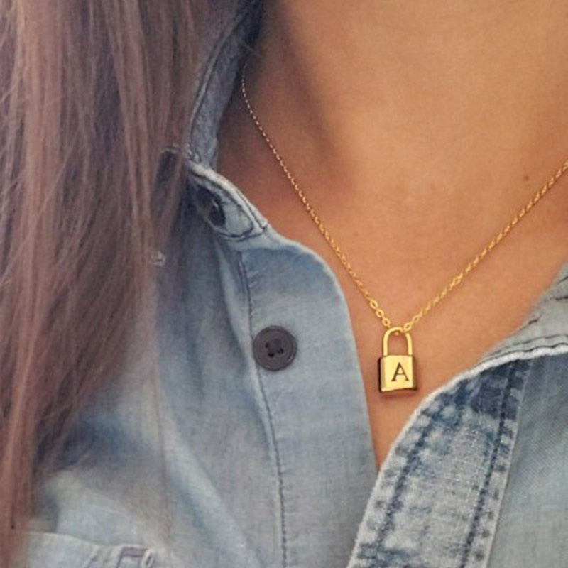 Woman's neck with Initial Lock Necklace and letter A on it.