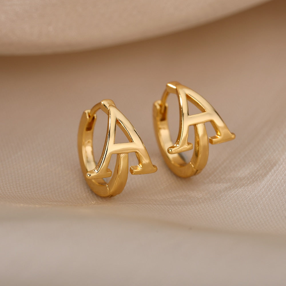 Letter Earrings A on beige background