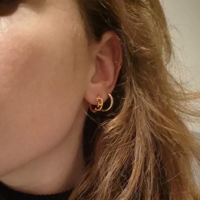 Letter Earrings E on a woman's ears